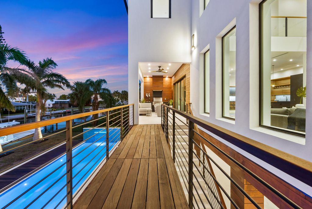 545 Kingfisher Lane, Longboat Key, Florida is a custom built modern canal front Longboat Key home with dramatic wide shell stone stair entrance, massive 60-inch ceramic tile flooring, 20-foot ceilings, skylights, lap-pool with 2 waterfall features, outdoor kitchen adjacent to indoor kitchen, and 5-car garage.
