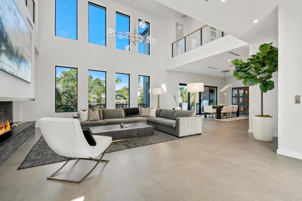 545 Kingfisher Lane, Longboat Key, Florida is a custom built modern canal front Longboat Key home with dramatic wide shell stone stair entrance, massive 60-inch ceramic tile flooring, 20-foot ceilings, skylights, lap-pool with 2 waterfall features, outdoor kitchen adjacent to indoor kitchen, and 5-car garage.