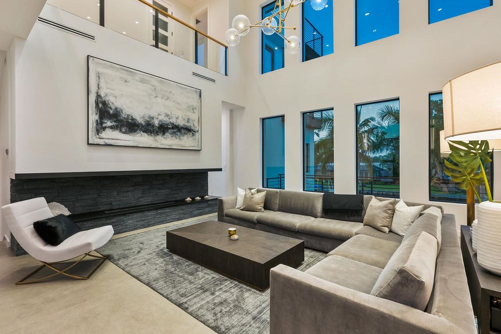 545 Kingfisher Lane, Longboat Key, Florida is a custom built modern canal front Longboat Key home with dramatic wide shell stone stair entrance, massive 60-inch ceramic tile flooring, 20-foot ceilings, skylights, lap-pool with 2 waterfall features, outdoor kitchen adjacent to indoor kitchen, and 5-car garage.