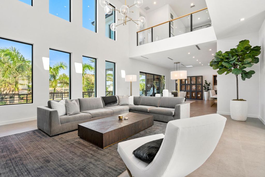 545 Kingfisher Lane, Longboat Key, Florida is a custom built modern canal front Longboat Key home with dramatic wide shell stone stair entrance, massive 60-inch ceramic tile flooring, 20-foot ceilings, skylights, lap-pool with 2 waterfall features, outdoor kitchen adjacent to indoor kitchen, and 5-car garage.