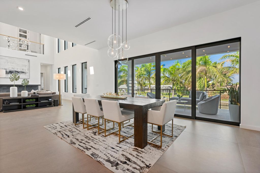545 Kingfisher Lane, Longboat Key, Florida is a custom built modern canal front Longboat Key home with dramatic wide shell stone stair entrance, massive 60-inch ceramic tile flooring, 20-foot ceilings, skylights, lap-pool with 2 waterfall features, outdoor kitchen adjacent to indoor kitchen, and 5-car garage.
