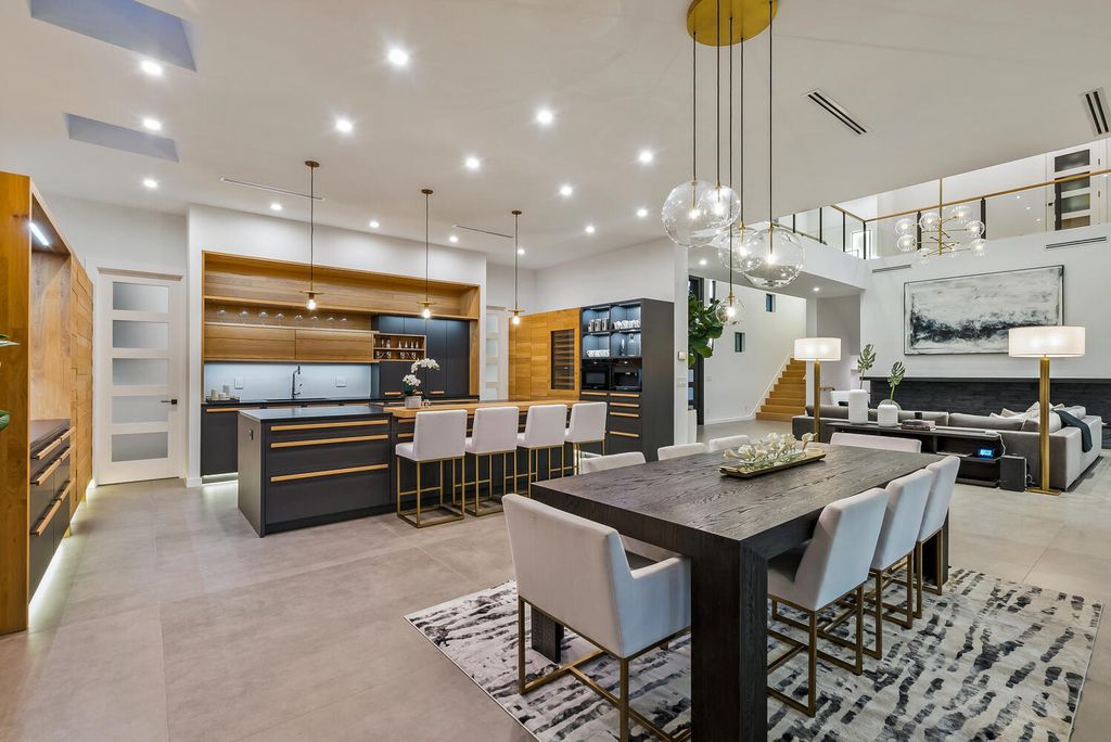 545 Kingfisher Lane, Longboat Key, Florida is a custom built modern canal front Longboat Key home with dramatic wide shell stone stair entrance, massive 60-inch ceramic tile flooring, 20-foot ceilings, skylights, lap-pool with 2 waterfall features, outdoor kitchen adjacent to indoor kitchen, and 5-car garage.