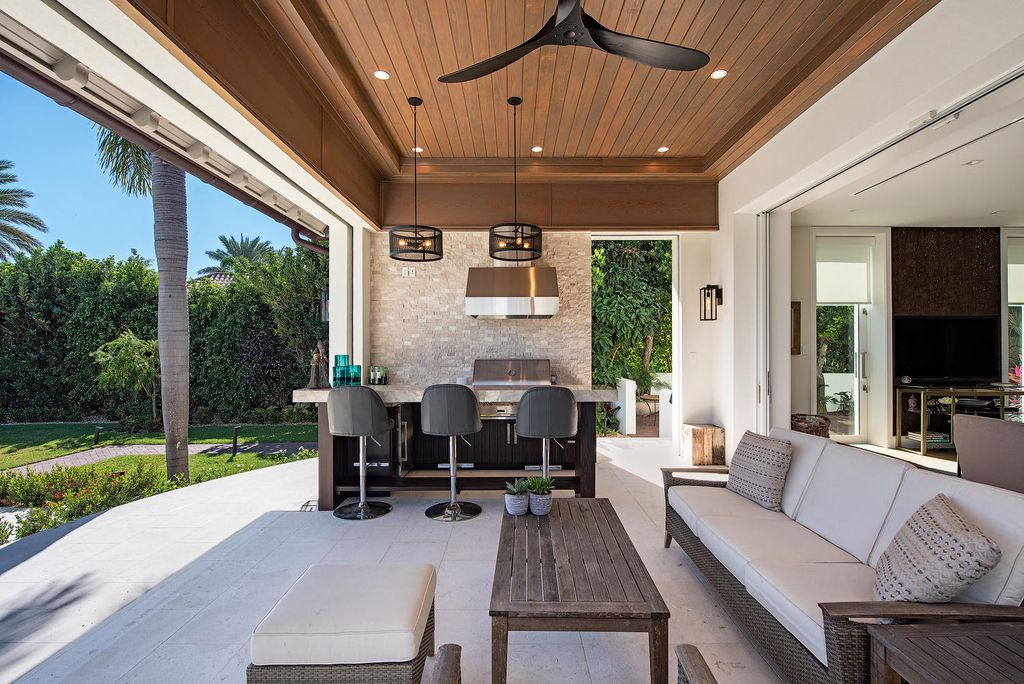 3595 Gin Lane, Naples, Florida is a gated property situated on nearly an acre overlooking Hidden Bay with quick access to the Gulf of Mexico, beautifully renovated and reimagined in 2018 with amenities as a private elevator, cherry wood library, double island in kitchen. 