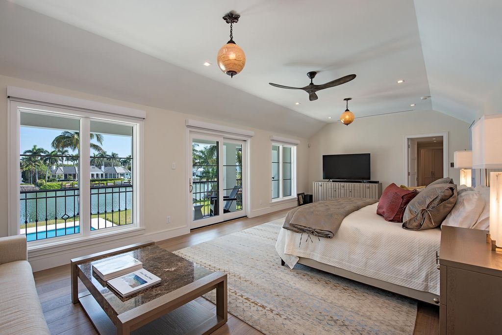 3595 Gin Lane, Naples, Florida is a gated property situated on nearly an acre overlooking Hidden Bay with quick access to the Gulf of Mexico, beautifully renovated and reimagined in 2018 with amenities as a private elevator, cherry wood library, double island in kitchen. 