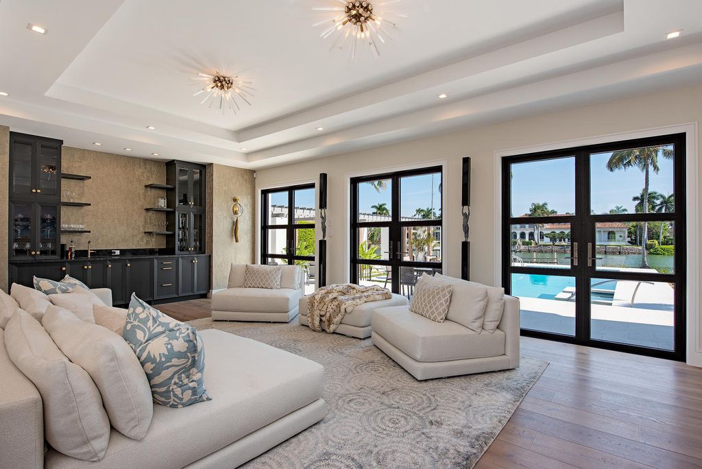 3595 Gin Lane, Naples, Florida is a gated property situated on nearly an acre overlooking Hidden Bay with quick access to the Gulf of Mexico, beautifully renovated and reimagined in 2018 with amenities as a private elevator, cherry wood library, double island in kitchen. 
