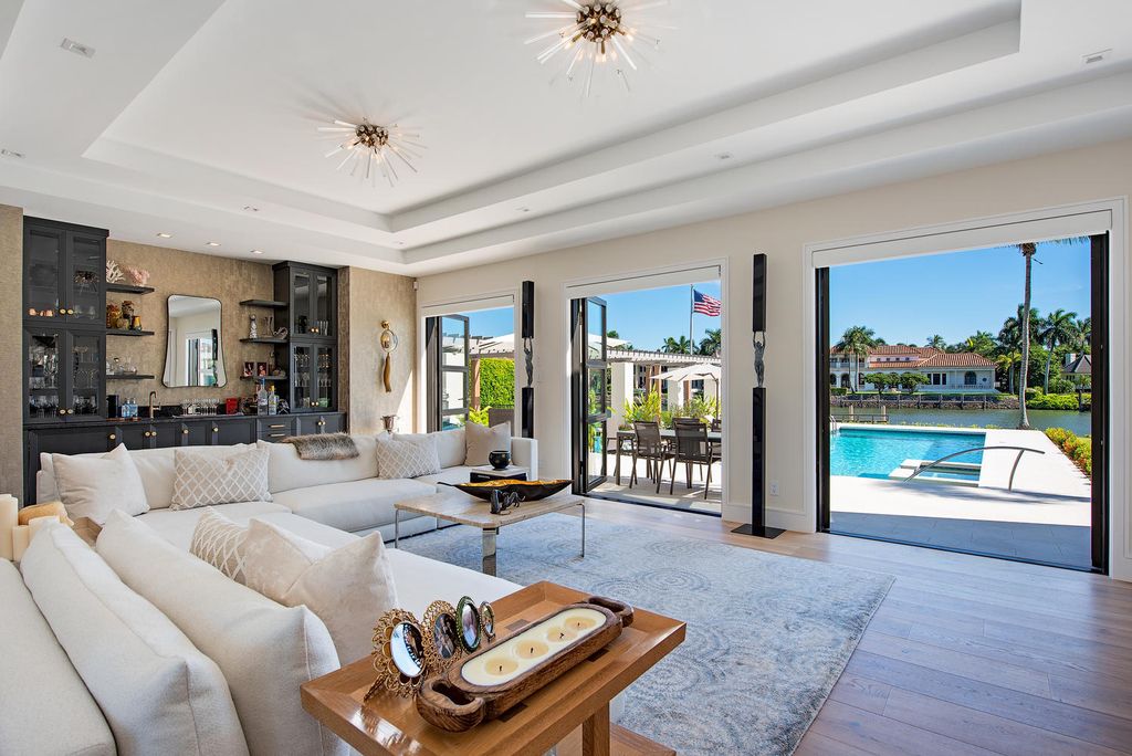 3595 Gin Lane, Naples, Florida is a gated property situated on nearly an acre overlooking Hidden Bay with quick access to the Gulf of Mexico, beautifully renovated and reimagined in 2018 with amenities as a private elevator, cherry wood library, double island in kitchen. 