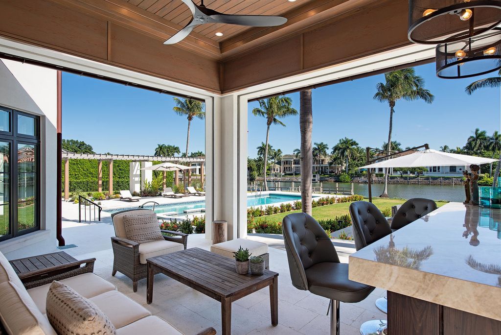 3595 Gin Lane, Naples, Florida is a gated property situated on nearly an acre overlooking Hidden Bay with quick access to the Gulf of Mexico, beautifully renovated and reimagined in 2018 with amenities as a private elevator, cherry wood library, double island in kitchen. 