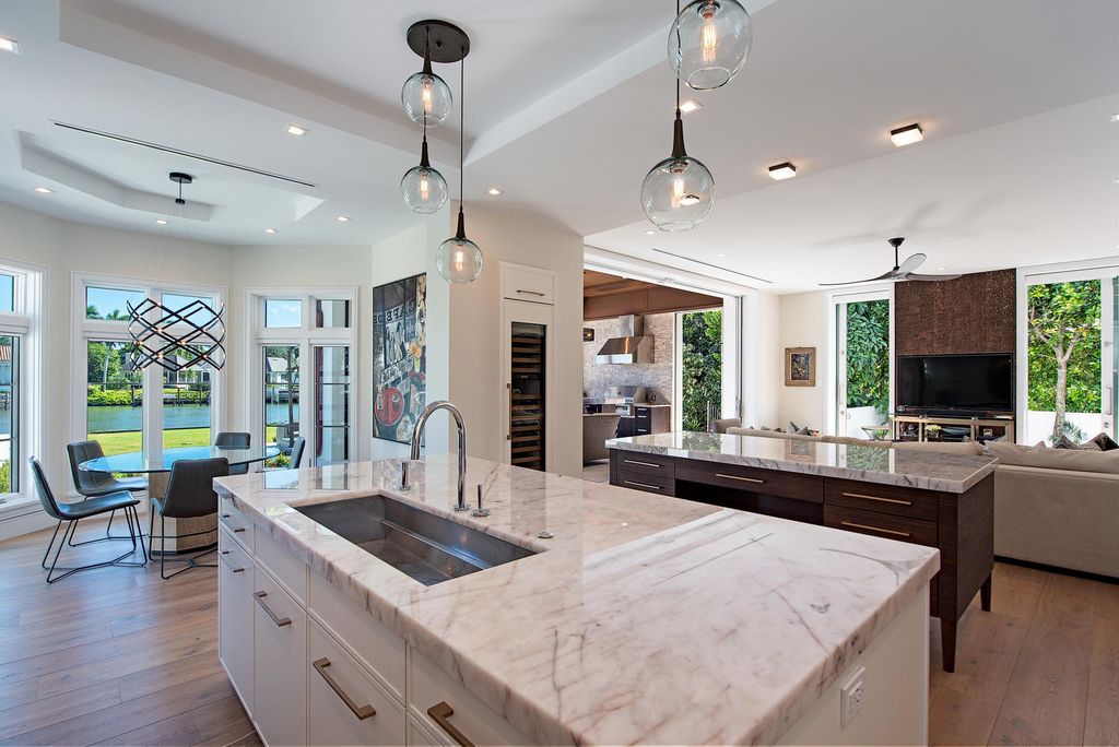 3595 Gin Lane, Naples, Florida is a gated property situated on nearly an acre overlooking Hidden Bay with quick access to the Gulf of Mexico, beautifully renovated and reimagined in 2018 with amenities as a private elevator, cherry wood library, double island in kitchen. 