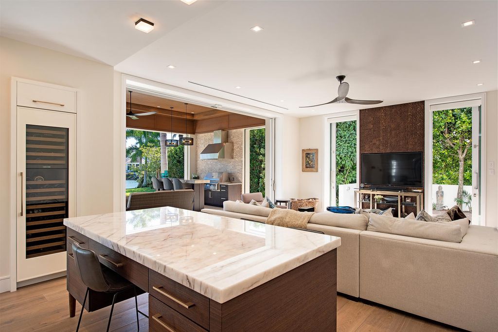 3595 Gin Lane, Naples, Florida is a gated property situated on nearly an acre overlooking Hidden Bay with quick access to the Gulf of Mexico, beautifully renovated and reimagined in 2018 with amenities as a private elevator, cherry wood library, double island in kitchen. 