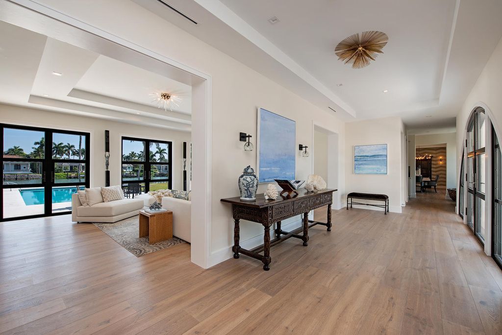 3595 Gin Lane, Naples, Florida is a gated property situated on nearly an acre overlooking Hidden Bay with quick access to the Gulf of Mexico, beautifully renovated and reimagined in 2018 with amenities as a private elevator, cherry wood library, double island in kitchen. 