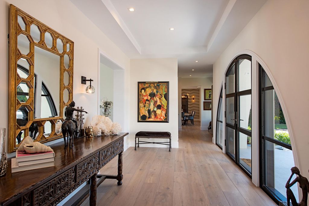 3595 Gin Lane, Naples, Florida is a gated property situated on nearly an acre overlooking Hidden Bay with quick access to the Gulf of Mexico, beautifully renovated and reimagined in 2018 with amenities as a private elevator, cherry wood library, double island in kitchen. 