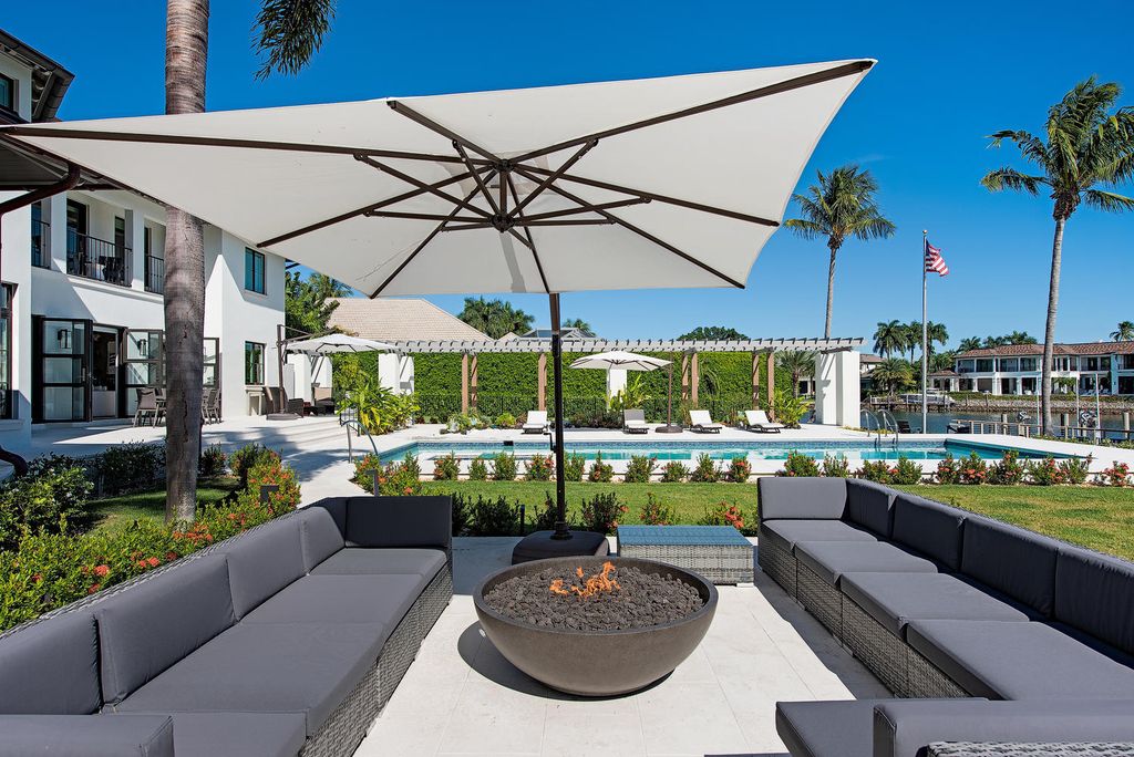 3595 Gin Lane, Naples, Florida is a gated property situated on nearly an acre overlooking Hidden Bay with quick access to the Gulf of Mexico, beautifully renovated and reimagined in 2018 with amenities as a private elevator, cherry wood library, double island in kitchen. 