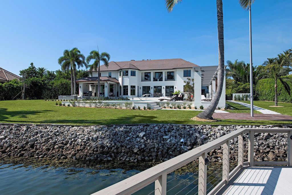 3595 Gin Lane, Naples, Florida is a gated property situated on nearly an acre overlooking Hidden Bay with quick access to the Gulf of Mexico, beautifully renovated and reimagined in 2018 with amenities as a private elevator, cherry wood library, double island in kitchen. 