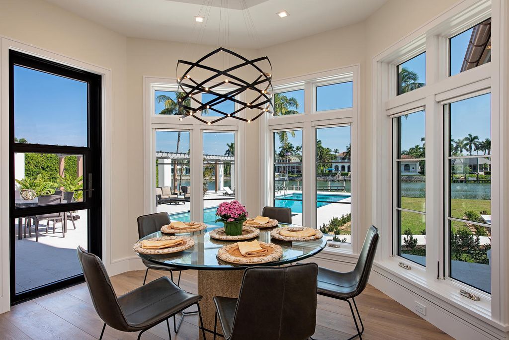 3595 Gin Lane, Naples, Florida is a gated property situated on nearly an acre overlooking Hidden Bay with quick access to the Gulf of Mexico, beautifully renovated and reimagined in 2018 with amenities as a private elevator, cherry wood library, double island in kitchen. 