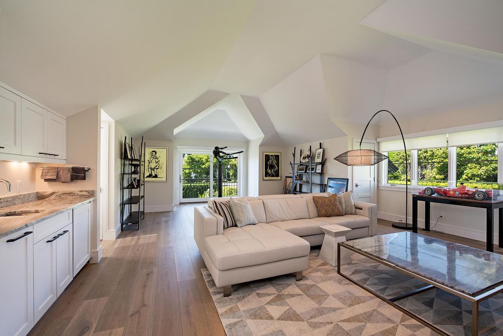 3595 Gin Lane, Naples, Florida is a gated property situated on nearly an acre overlooking Hidden Bay with quick access to the Gulf of Mexico, beautifully renovated and reimagined in 2018 with amenities as a private elevator, cherry wood library, double island in kitchen. 