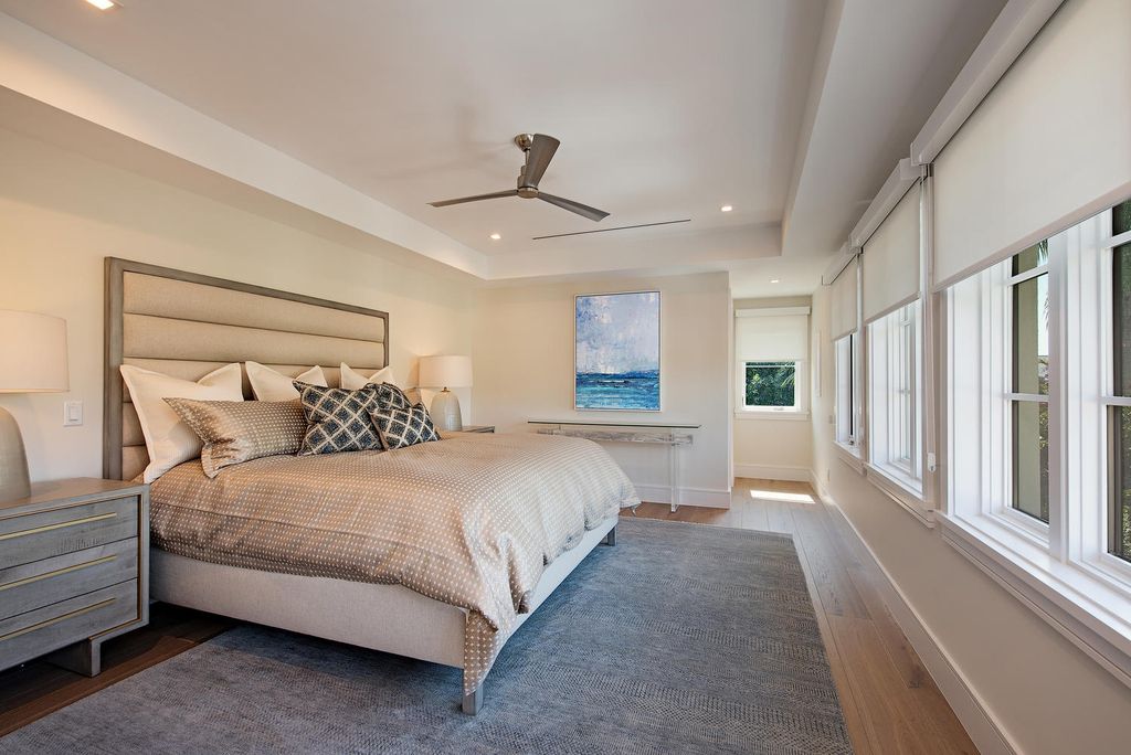 3595 Gin Lane, Naples, Florida is a gated property situated on nearly an acre overlooking Hidden Bay with quick access to the Gulf of Mexico, beautifully renovated and reimagined in 2018 with amenities as a private elevator, cherry wood library, double island in kitchen. 