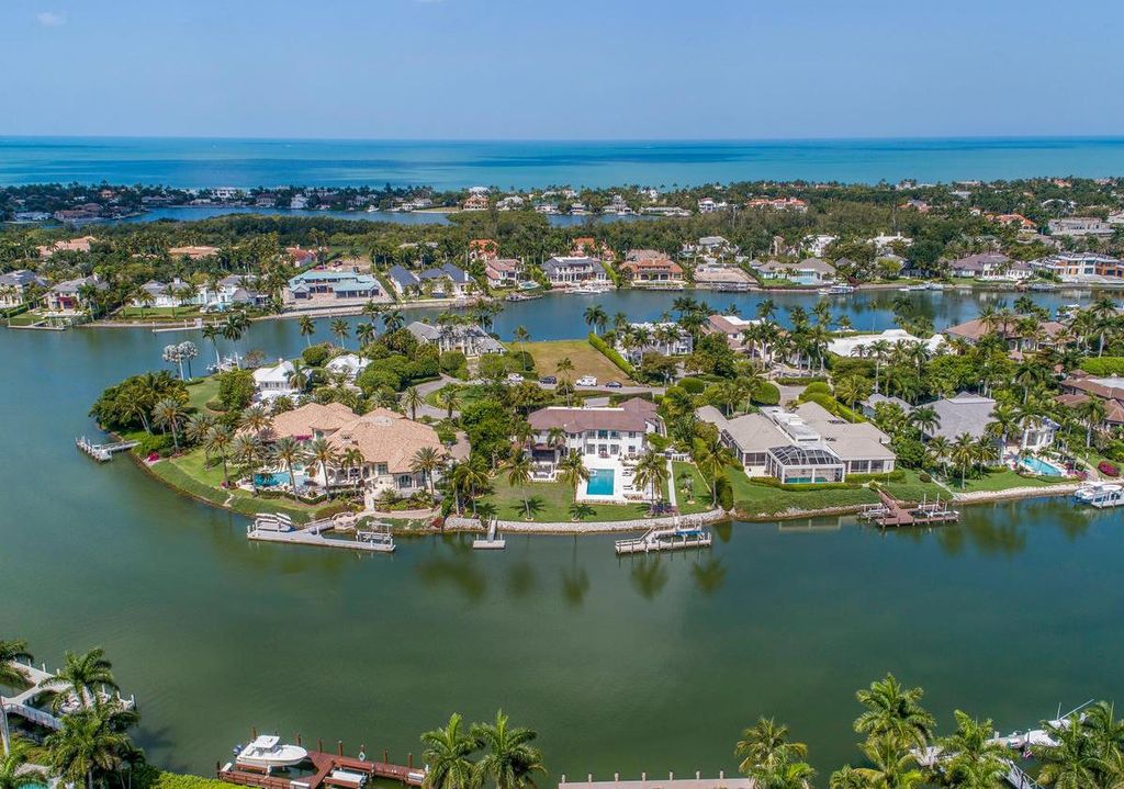 3595 Gin Lane, Naples, Florida is a gated property situated on nearly an acre overlooking Hidden Bay with quick access to the Gulf of Mexico, beautifully renovated and reimagined in 2018 with amenities as a private elevator, cherry wood library, double island in kitchen. 