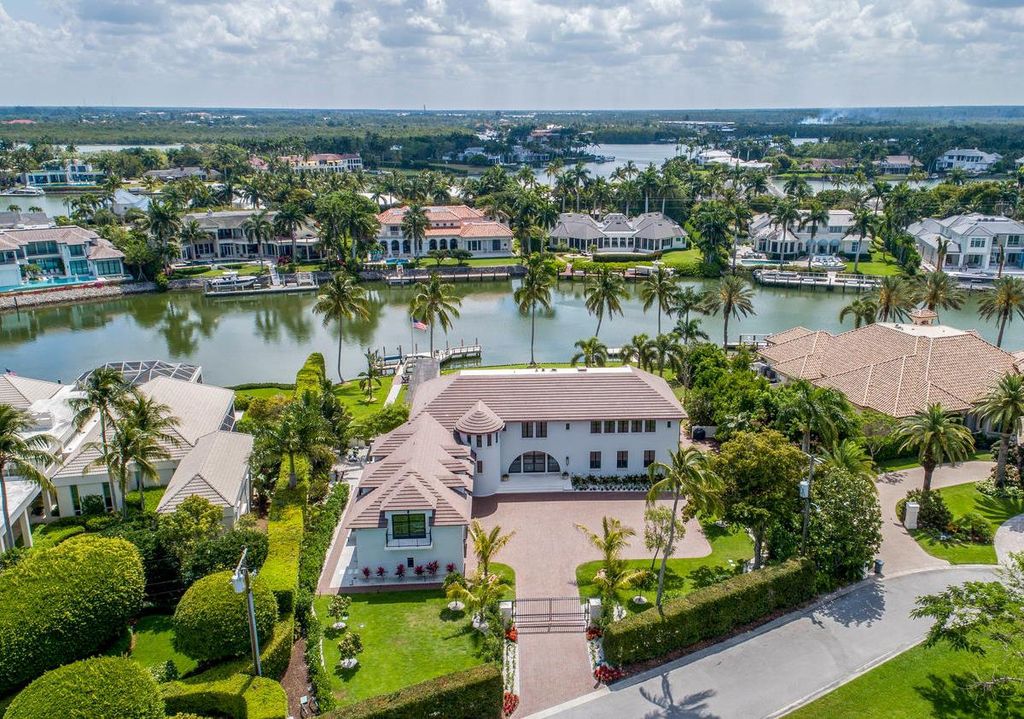 3595 Gin Lane, Naples, Florida is a gated property situated on nearly an acre overlooking Hidden Bay with quick access to the Gulf of Mexico, beautifully renovated and reimagined in 2018 with amenities as a private elevator, cherry wood library, double island in kitchen. 