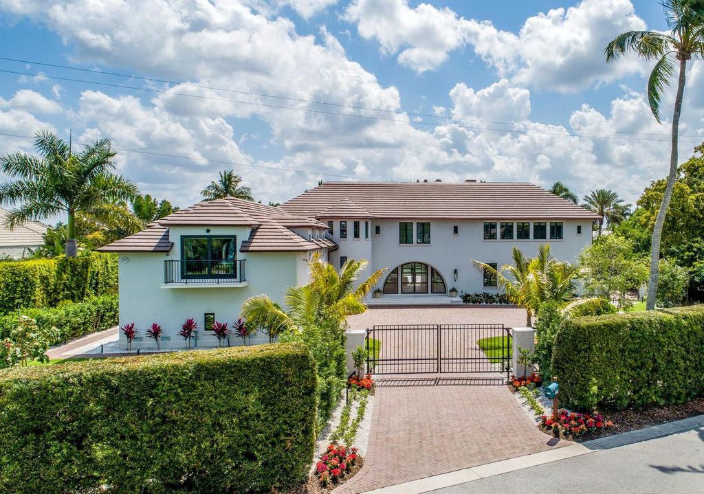 3595 Gin Lane, Naples, Florida is a gated property situated on nearly an acre overlooking Hidden Bay with quick access to the Gulf of Mexico, beautifully renovated and reimagined in 2018 with amenities as a private elevator, cherry wood library, double island in kitchen. 