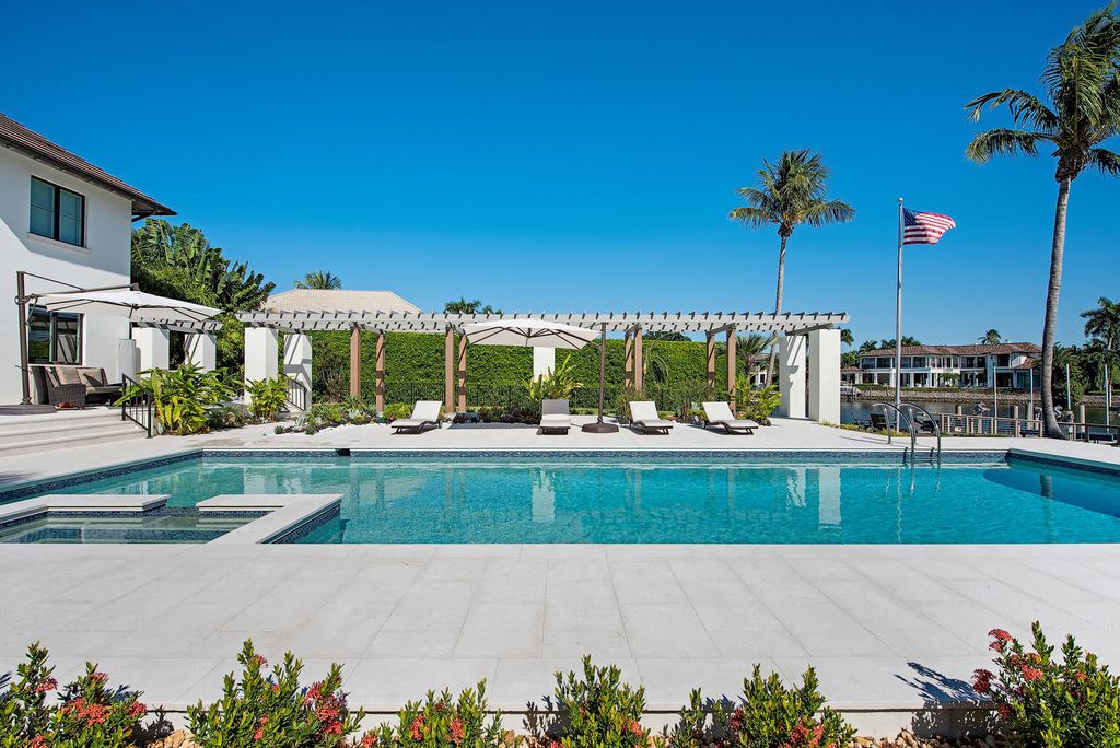 3595 Gin Lane, Naples, Florida is a gated property situated on nearly an acre overlooking Hidden Bay with quick access to the Gulf of Mexico, beautifully renovated and reimagined in 2018 with amenities as a private elevator, cherry wood library, double island in kitchen. 