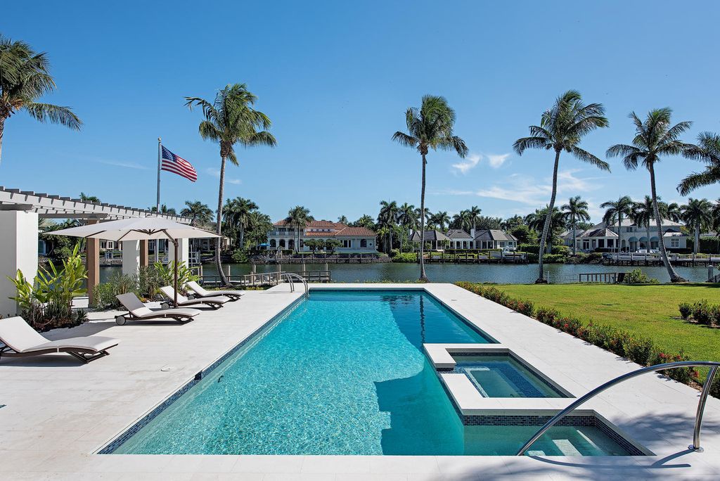 3595 Gin Lane, Naples, Florida is a gated property situated on nearly an acre overlooking Hidden Bay with quick access to the Gulf of Mexico, beautifully renovated and reimagined in 2018 with amenities as a private elevator, cherry wood library, double island in kitchen. 