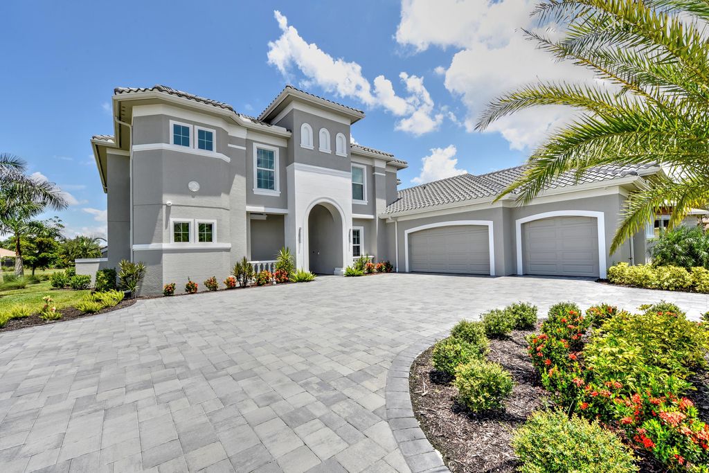 13335 Whispering Oaks Drive, Fort Myers, Florida is a custom built home by Royal Corinthian Homes in the highly sought-after luxury golf community Verandah with oversized tile throughout, custom cabinets including paneled refrigerator, thermidor appliance package, quartz kitchen countertops, interior mezzanine balcony, dual master suites.
