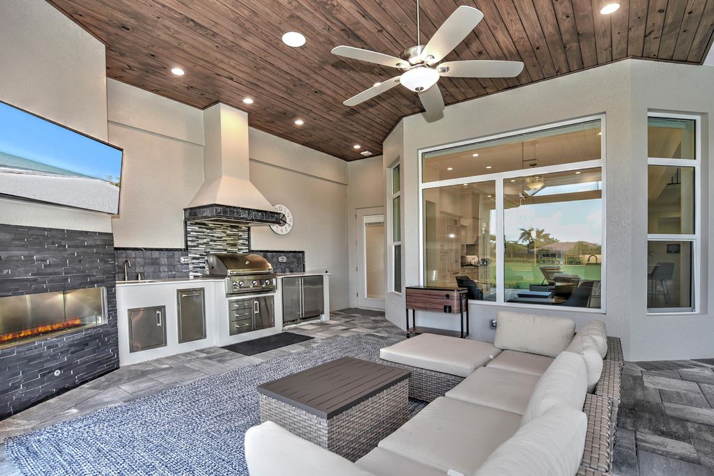 13335 Whispering Oaks Drive, Fort Myers, Florida is a custom built home by Royal Corinthian Homes in the highly sought-after luxury golf community Verandah with oversized tile throughout, custom cabinets including paneled refrigerator, thermidor appliance package, quartz kitchen countertops, interior mezzanine balcony, dual master suites.