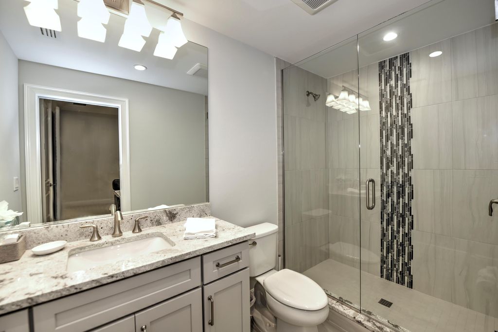 13335 Whispering Oaks Drive, Fort Myers, Florida is a custom built home by Royal Corinthian Homes in the highly sought-after luxury golf community Verandah with oversized tile throughout, custom cabinets including paneled refrigerator, thermidor appliance package, quartz kitchen countertops, interior mezzanine balcony, dual master suites.