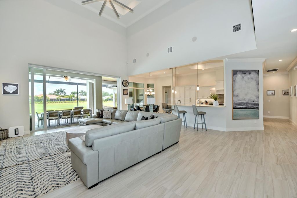 13335 Whispering Oaks Drive, Fort Myers, Florida is a custom built home by Royal Corinthian Homes in the highly sought-after luxury golf community Verandah with oversized tile throughout, custom cabinets including paneled refrigerator, thermidor appliance package, quartz kitchen countertops, interior mezzanine balcony, dual master suites.