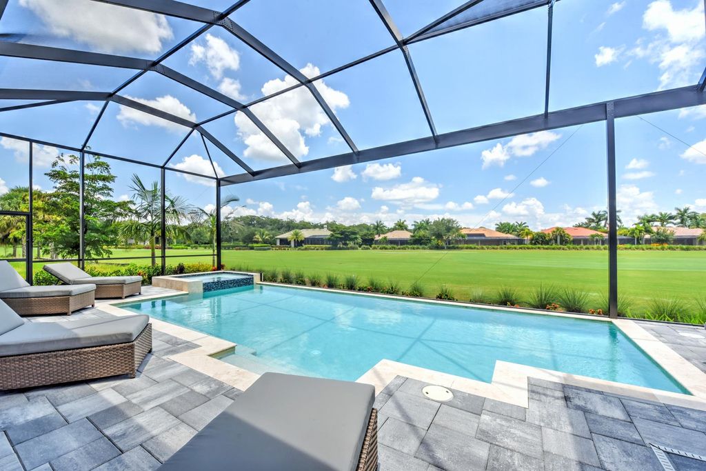 13335 Whispering Oaks Drive, Fort Myers, Florida is a custom built home by Royal Corinthian Homes in the highly sought-after luxury golf community Verandah with oversized tile throughout, custom cabinets including paneled refrigerator, thermidor appliance package, quartz kitchen countertops, interior mezzanine balcony, dual master suites.