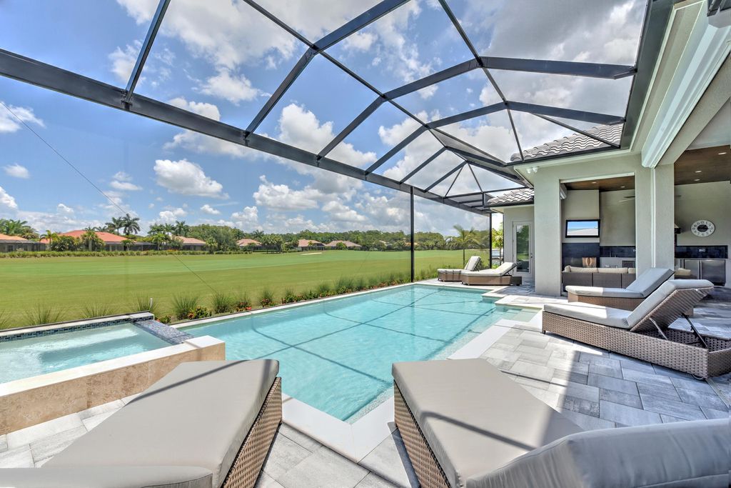 13335 Whispering Oaks Drive, Fort Myers, Florida is a custom built home by Royal Corinthian Homes in the highly sought-after luxury golf community Verandah with oversized tile throughout, custom cabinets including paneled refrigerator, thermidor appliance package, quartz kitchen countertops, interior mezzanine balcony, dual master suites.