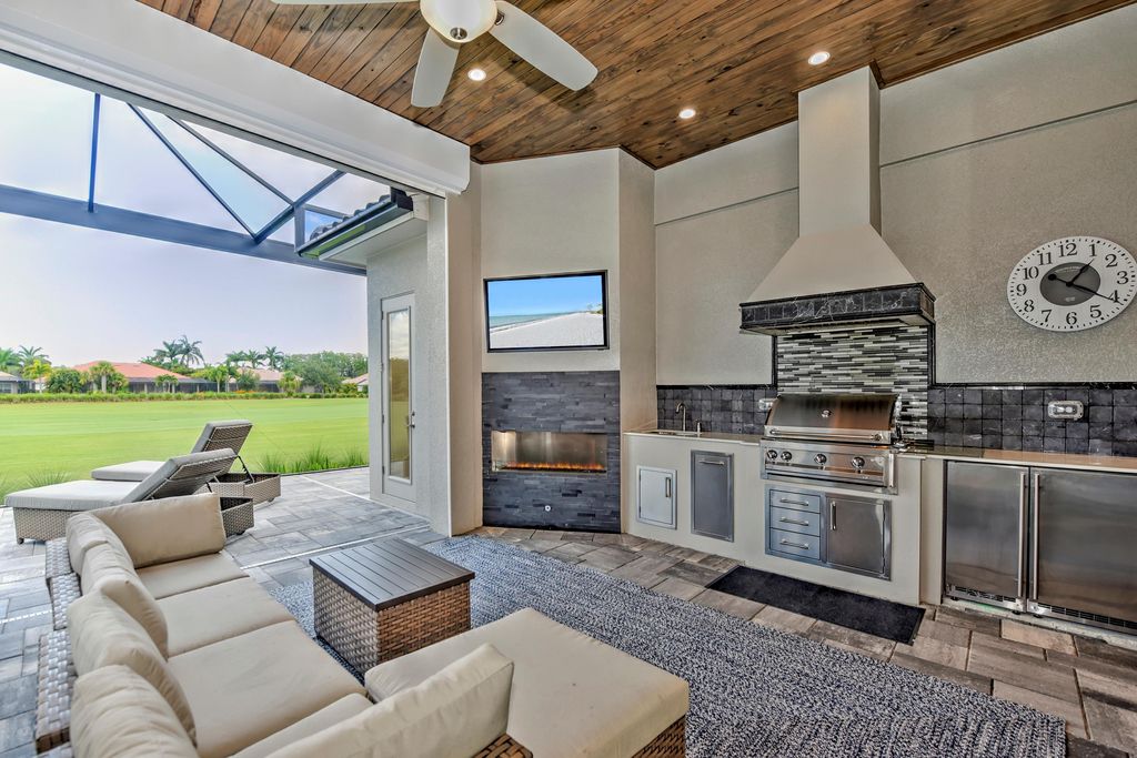 13335 Whispering Oaks Drive, Fort Myers, Florida is a custom built home by Royal Corinthian Homes in the highly sought-after luxury golf community Verandah with oversized tile throughout, custom cabinets including paneled refrigerator, thermidor appliance package, quartz kitchen countertops, interior mezzanine balcony, dual master suites.