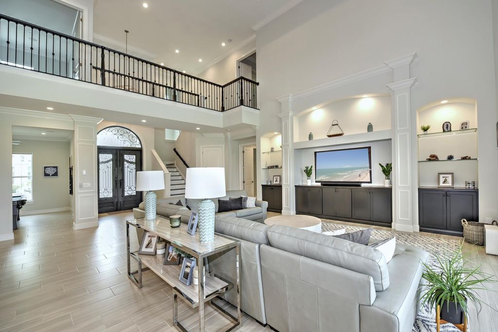 13335 Whispering Oaks Drive, Fort Myers, Florida is a custom built home by Royal Corinthian Homes in the highly sought-after luxury golf community Verandah with oversized tile throughout, custom cabinets including paneled refrigerator, thermidor appliance package, quartz kitchen countertops, interior mezzanine balcony, dual master suites.
