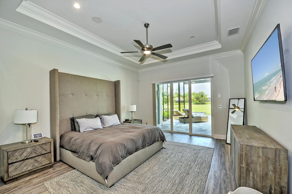 13335 Whispering Oaks Drive, Fort Myers, Florida is a custom built home by Royal Corinthian Homes in the highly sought-after luxury golf community Verandah with oversized tile throughout, custom cabinets including paneled refrigerator, thermidor appliance package, quartz kitchen countertops, interior mezzanine balcony, dual master suites.