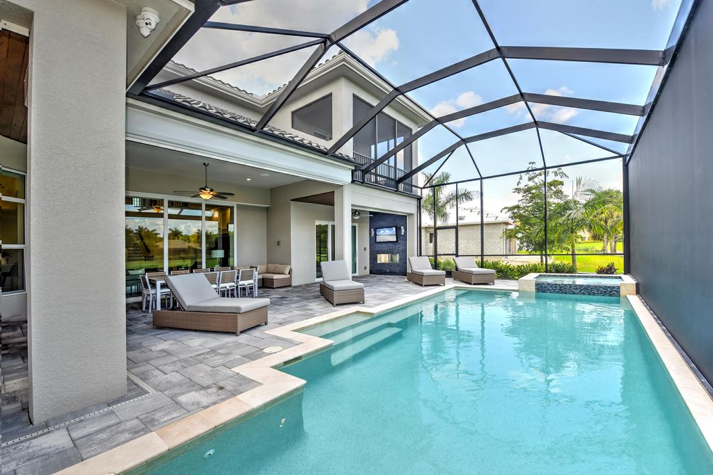 13335 Whispering Oaks Drive, Fort Myers, Florida is a custom built home by Royal Corinthian Homes in the highly sought-after luxury golf community Verandah with oversized tile throughout, custom cabinets including paneled refrigerator, thermidor appliance package, quartz kitchen countertops, interior mezzanine balcony, dual master suites.