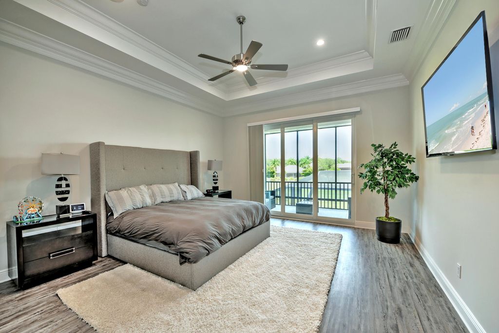 13335 Whispering Oaks Drive, Fort Myers, Florida is a custom built home by Royal Corinthian Homes in the highly sought-after luxury golf community Verandah with oversized tile throughout, custom cabinets including paneled refrigerator, thermidor appliance package, quartz kitchen countertops, interior mezzanine balcony, dual master suites.