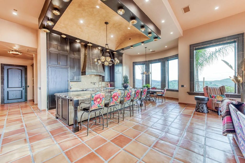 22137 Oak Glen Lane, Friant, California is a newly constructed home boasts 360 degree views of the snow-capped Sierras, Millerton Lake, Eagle Springs Golf Course and the City, enjoying the massive resort-style pool which includes a waterslide, private grotto and recessed fire pit.
