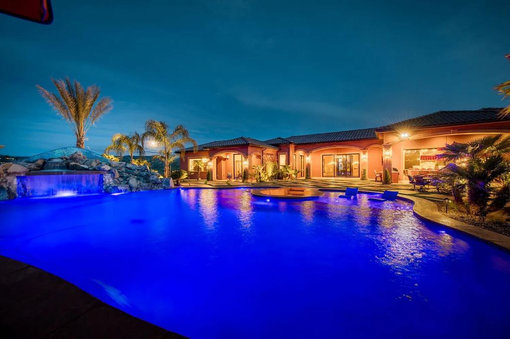 22137 Oak Glen Lane, Friant, California is a newly constructed home boasts 360 degree views of the snow-capped Sierras, Millerton Lake, Eagle Springs Golf Course and the City, enjoying the massive resort-style pool which includes a waterslide, private grotto and recessed fire pit.