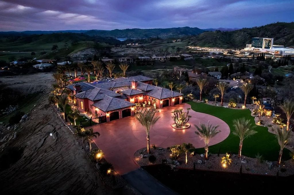 22137 Oak Glen Lane, Friant, California is a newly constructed home boasts 360 degree views of the snow-capped Sierras, Millerton Lake, Eagle Springs Golf Course and the City, enjoying the massive resort-style pool which includes a waterslide, private grotto and recessed fire pit.