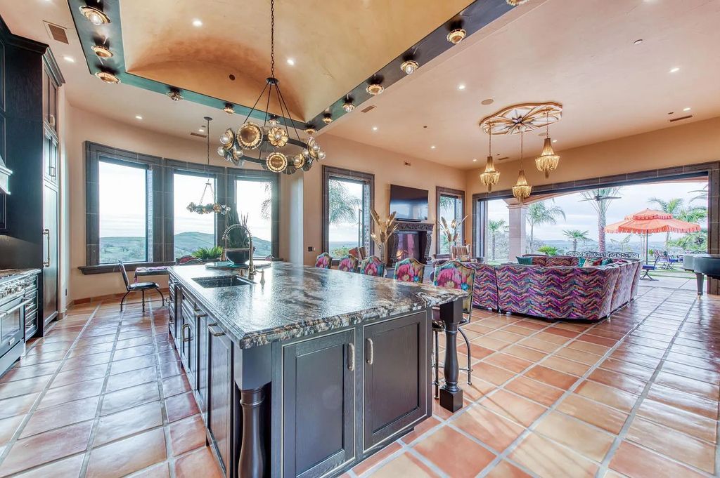 22137 Oak Glen Lane, Friant, California is a newly constructed home boasts 360 degree views of the snow-capped Sierras, Millerton Lake, Eagle Springs Golf Course and the City, enjoying the massive resort-style pool which includes a waterslide, private grotto and recessed fire pit.