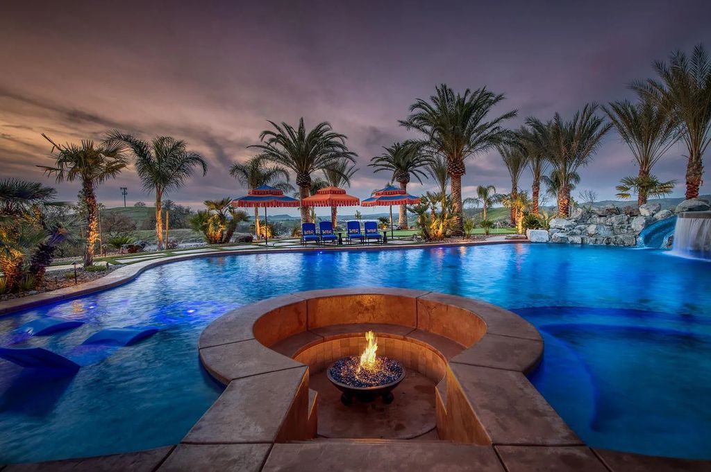 22137 Oak Glen Lane, Friant, California is a newly constructed home boasts 360 degree views of the snow-capped Sierras, Millerton Lake, Eagle Springs Golf Course and the City, enjoying the massive resort-style pool which includes a waterslide, private grotto and recessed fire pit.