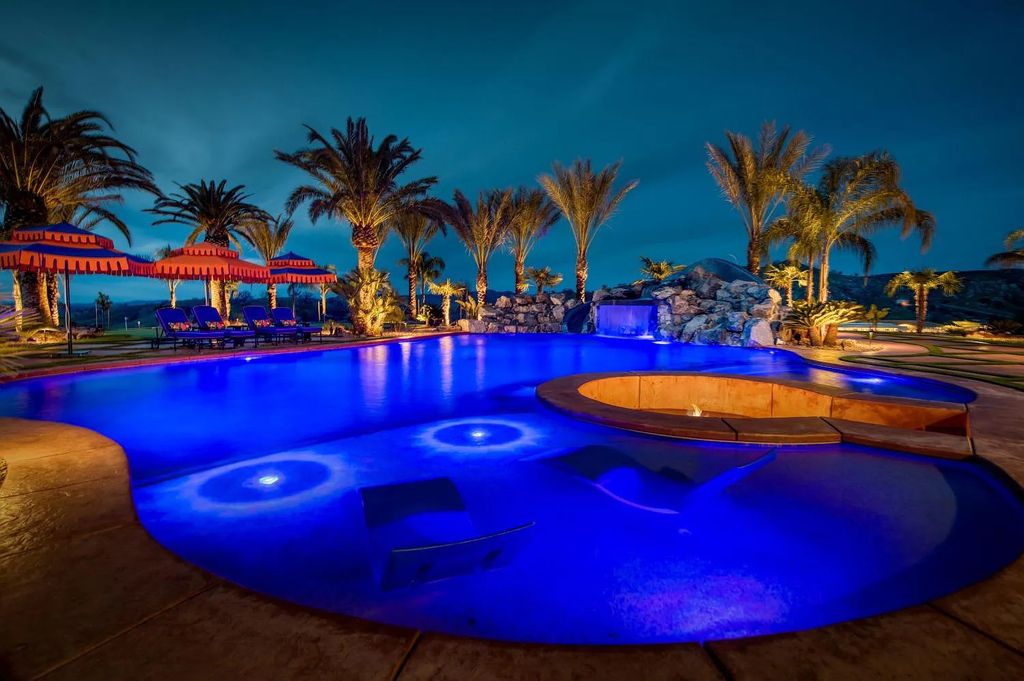 22137 Oak Glen Lane, Friant, California is a newly constructed home boasts 360 degree views of the snow-capped Sierras, Millerton Lake, Eagle Springs Golf Course and the City, enjoying the massive resort-style pool which includes a waterslide, private grotto and recessed fire pit.