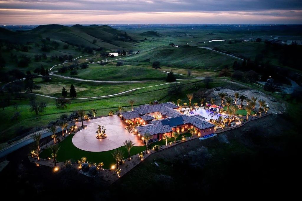 22137 Oak Glen Lane, Friant, California is a newly constructed home boasts 360 degree views of the snow-capped Sierras, Millerton Lake, Eagle Springs Golf Course and the City, enjoying the massive resort-style pool which includes a waterslide, private grotto and recessed fire pit.