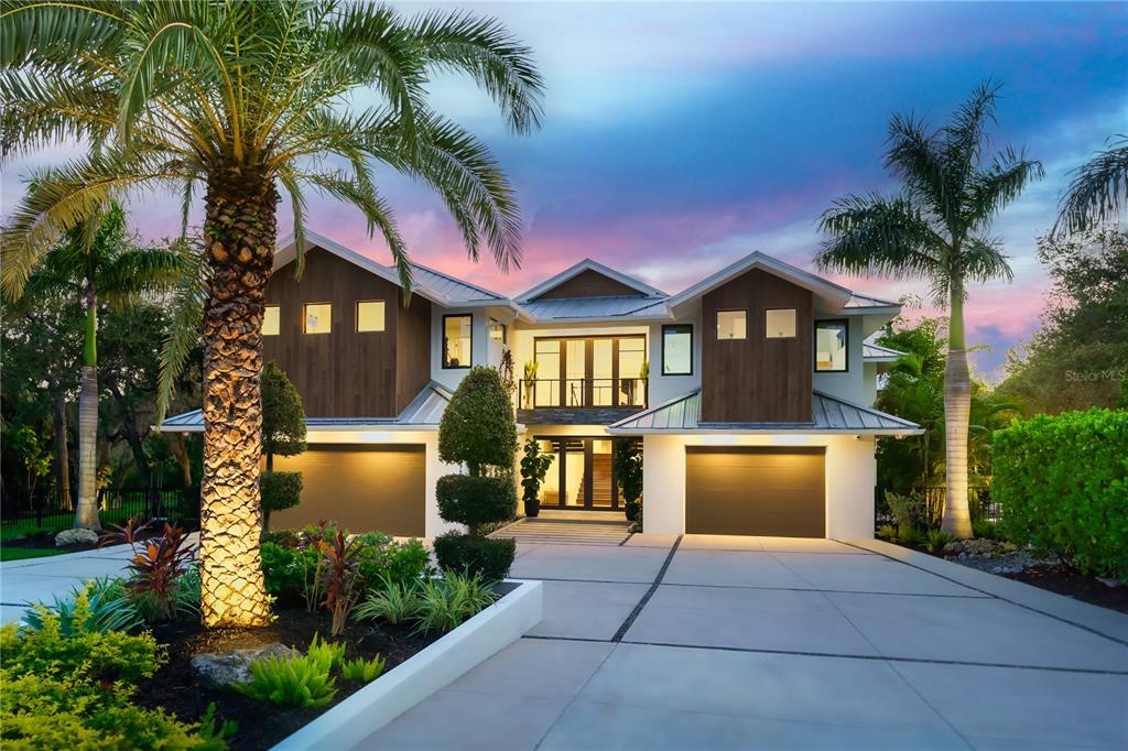 3940 Elysian Woods Lane, Sarasota, Florida is a mature landscaped estate is nestled on 1.47 acres and completely private in a small, gated community with only eight homes, was built with meticulous craftsmanship and bespoke finishes throughout.