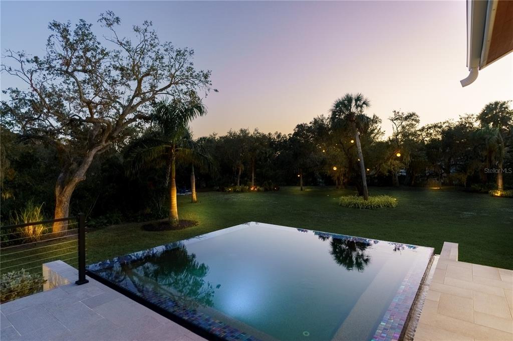 3940 Elysian Woods Lane, Sarasota, Florida is a mature landscaped estate is nestled on 1.47 acres and completely private in a small, gated community with only eight homes, was built with meticulous craftsmanship and bespoke finishes throughout.