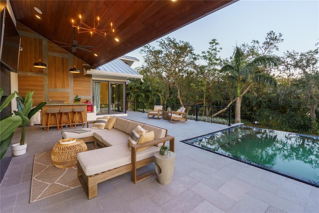 3940 Elysian Woods Lane, Sarasota, Florida is a mature landscaped estate is nestled on 1.47 acres and completely private in a small, gated community with only eight homes, was built with meticulous craftsmanship and bespoke finishes throughout.
