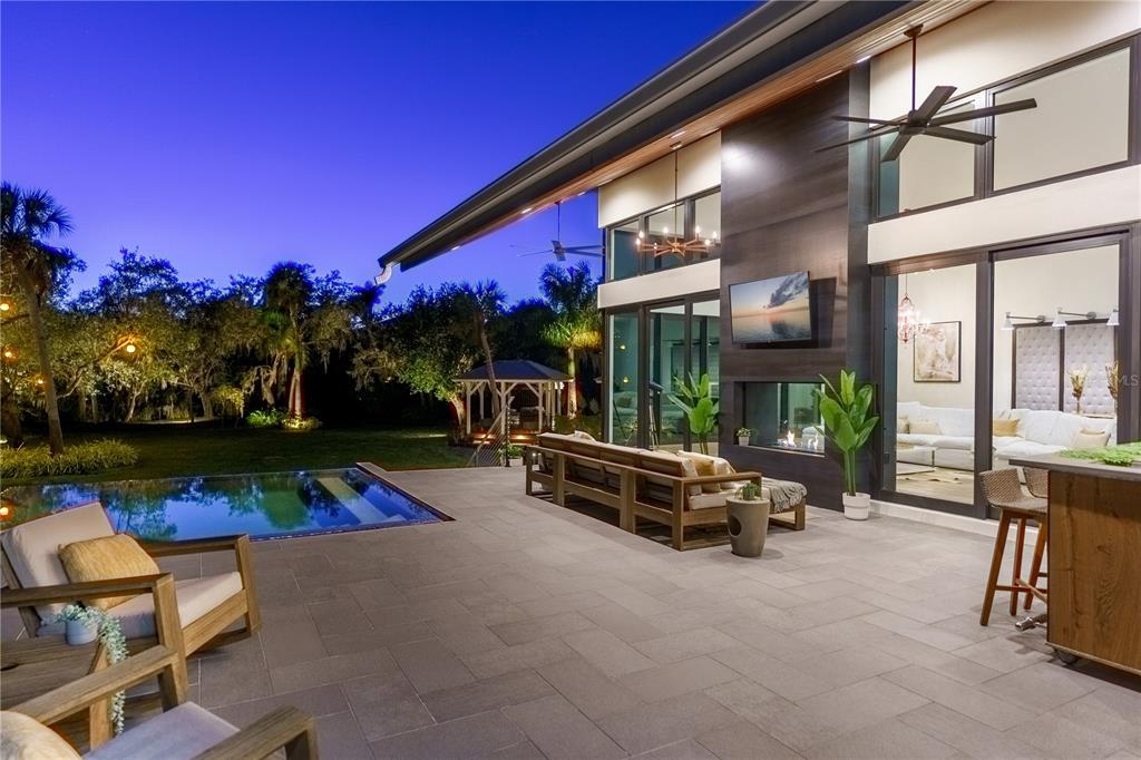 3940 Elysian Woods Lane, Sarasota, Florida is a mature landscaped estate is nestled on 1.47 acres and completely private in a small, gated community with only eight homes, was built with meticulous craftsmanship and bespoke finishes throughout.