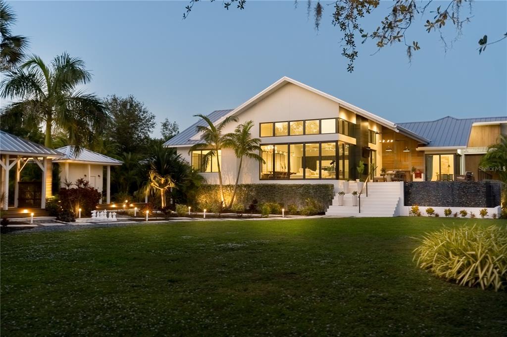 3940 Elysian Woods Lane, Sarasota, Florida is a mature landscaped estate is nestled on 1.47 acres and completely private in a small, gated community with only eight homes, was built with meticulous craftsmanship and bespoke finishes throughout.