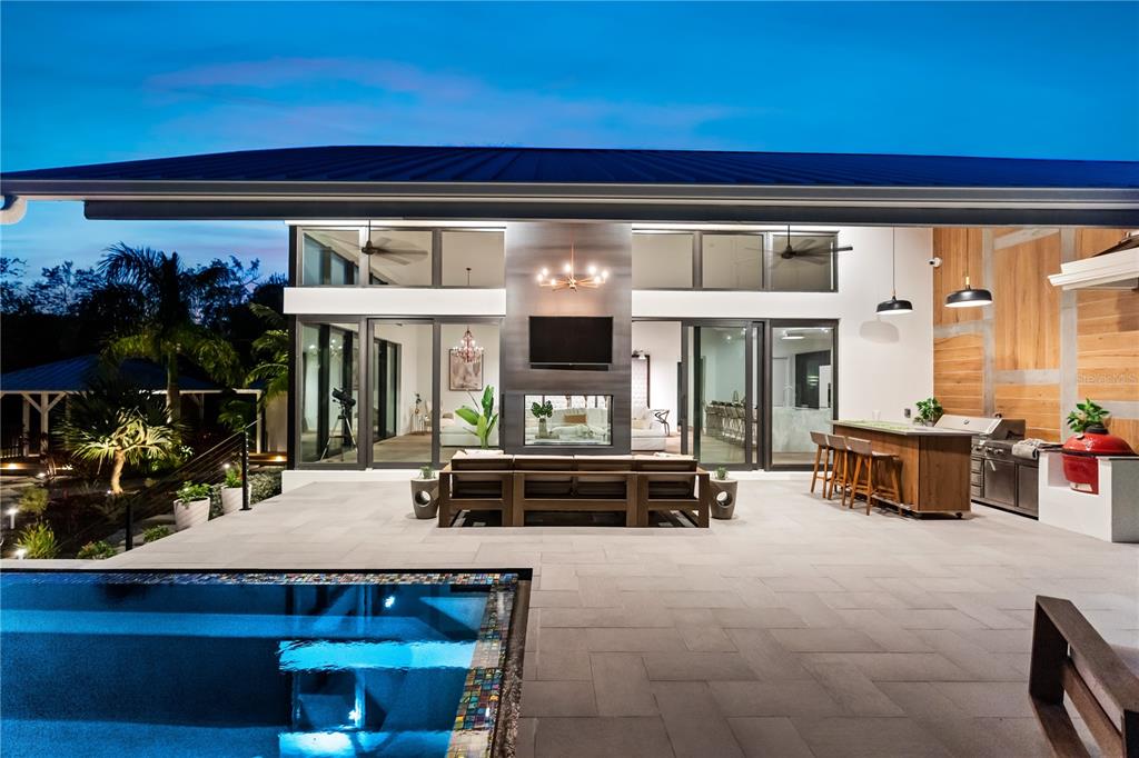 3940 Elysian Woods Lane, Sarasota, Florida is a mature landscaped estate is nestled on 1.47 acres and completely private in a small, gated community with only eight homes, was built with meticulous craftsmanship and bespoke finishes throughout.