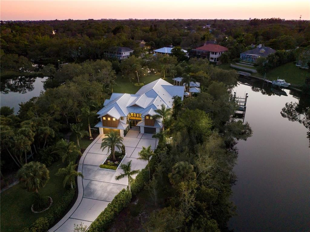 3940 Elysian Woods Lane, Sarasota, Florida is a mature landscaped estate is nestled on 1.47 acres and completely private in a small, gated community with only eight homes, was built with meticulous craftsmanship and bespoke finishes throughout.